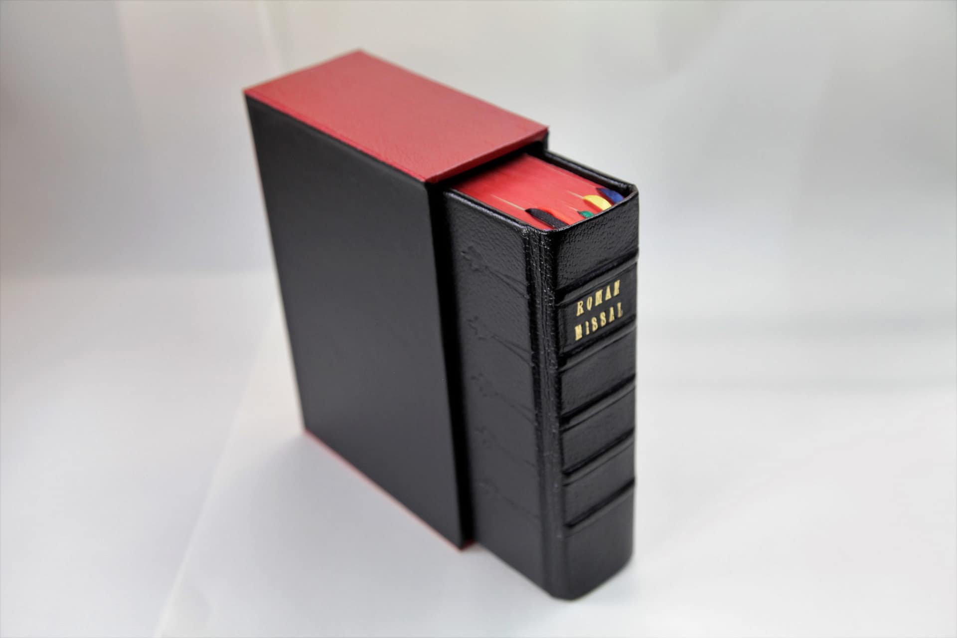 Slipcase in black and red with a daily missal half sticking out of it