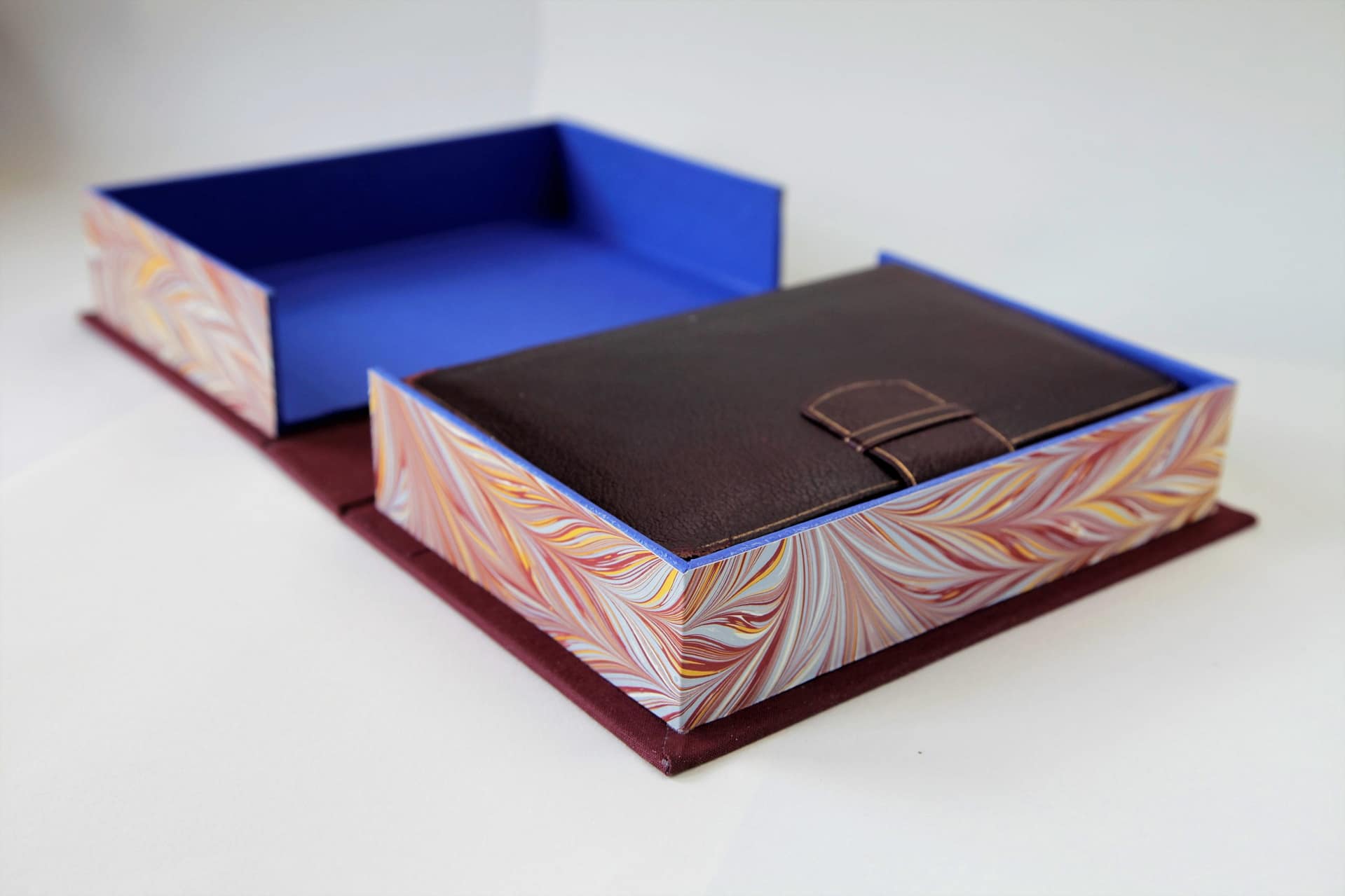 Clamshell box fully open leather book inside maroon cloth cover marbled edges blue interior