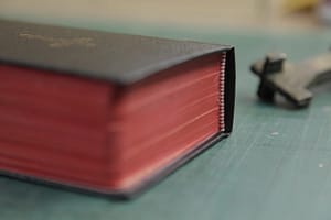 Bible with refreshed red page edges and brass cross