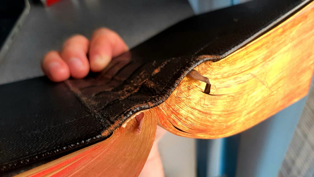 top down view of an open tightback binding with missing ribbons