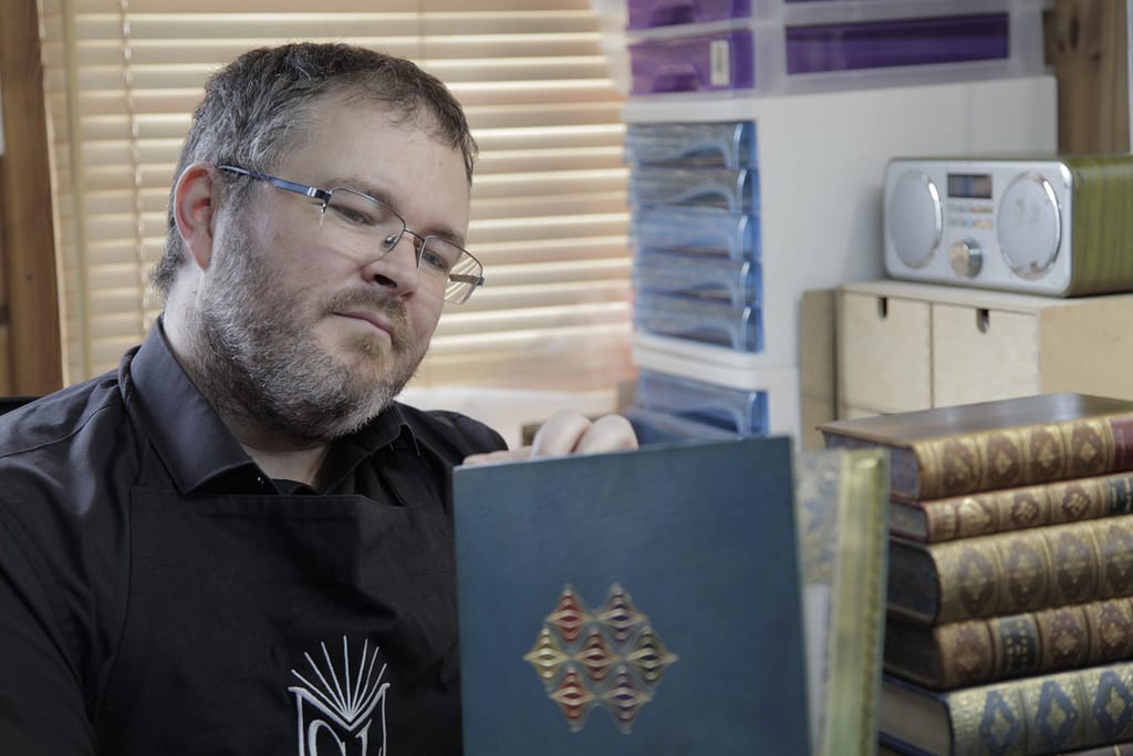 Bookbinder examining a fine binding