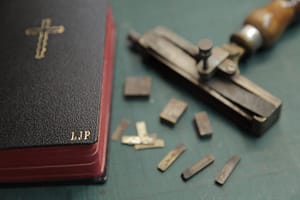 Bible with gold cross and monogram letter